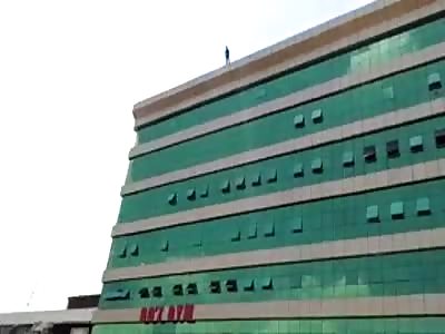 (New Angle) Man Survives Suicide Attempt by Jumping from Building in Uganda