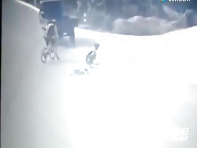 Bicyclist gets ran over by a tricycle 