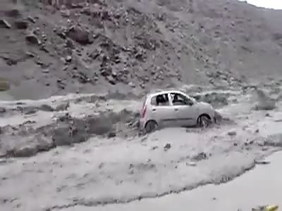 Car is washed away by water