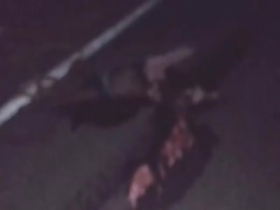 MAN WITH DESTROYED HEAD IN PAVEMENT