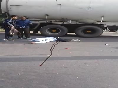 DEAD MOTORCYCLISTS ON PAVEMENT AFTER SUFFERING ACCIDENT