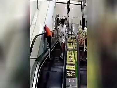 A Chinese boy's head gets stuck in an escalator
