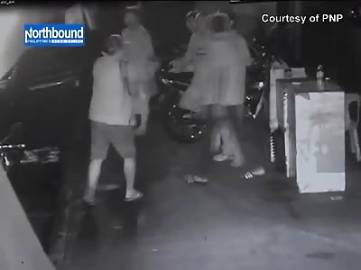 Man Wearing Shorts Shoots at a Group of People Chatting and Smoking 