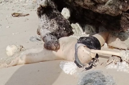 Decomposed body of drowned fishermen laying on the beach 