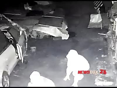 two thieves stealing wheels from an off-road vehicle