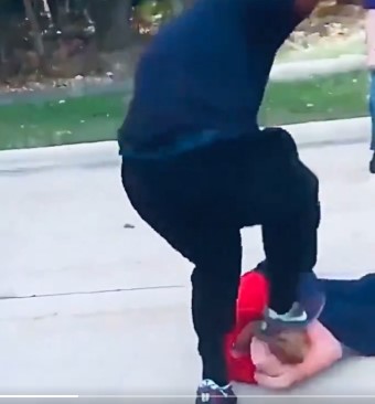  small white cross beaten by a giant black man