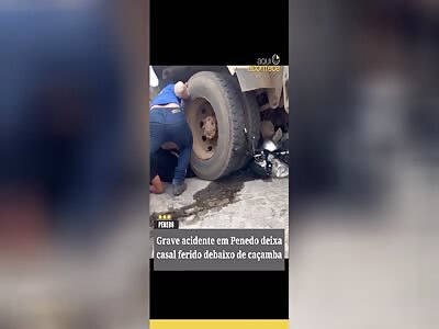 COUPLE INJURED UNDER THE TRUCK WHEELS