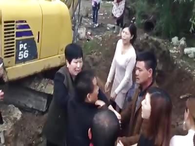 Digger hits woman into pit 