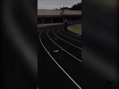 Boy throws volley ball on guard bike tire
