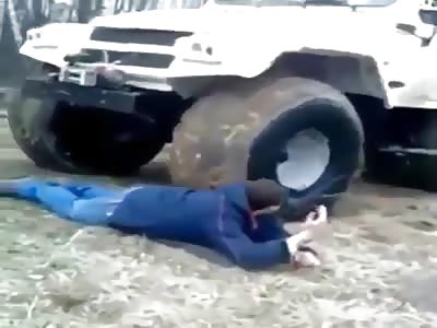 crazy man lets a big bear 4x4 four wheeler run over him