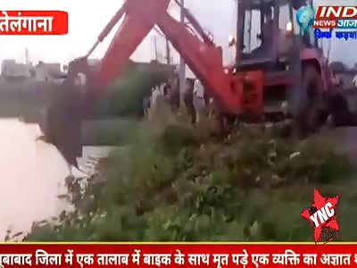 Excavator pulls carcass out of the water