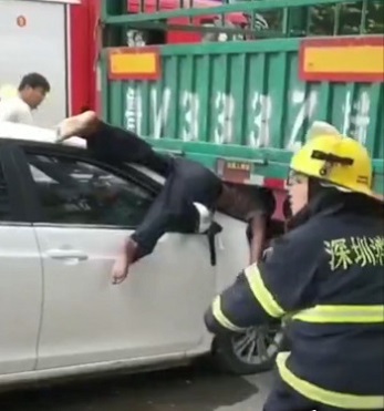 Dude Sandwiched Between Car and Truck.