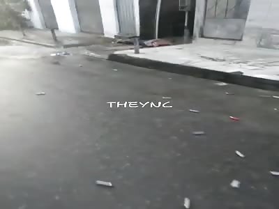 Headless corpse lying in the street.