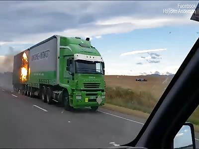 Truck speeds down highway while on fire