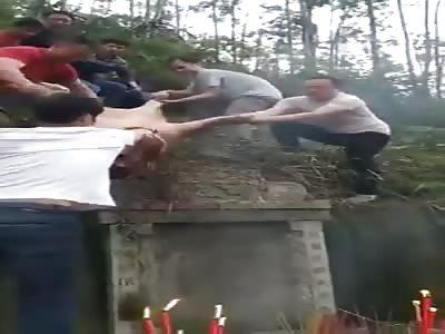 Covering A Tombstone with Pig Blood