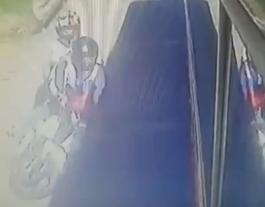 Biker Falls Head First Under Bus