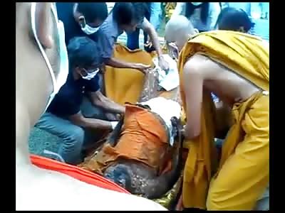 Bizarre Video of an Important Monk being Prepared for Show in his Glass Coffin 
