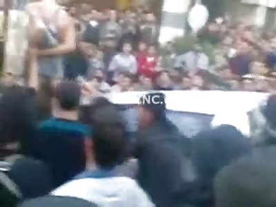 A Very Brutal Prolonged Public Hanging..Man is Dangling as he is Beaten by Crowd