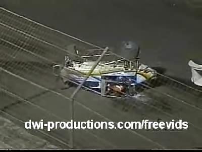 Gasoline pouring from a racecar, lighting up