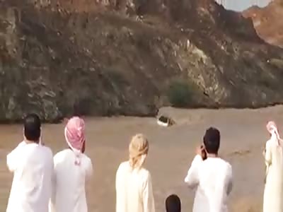 A VAN WITH ARABS DRIFTING IN FLOOD